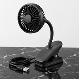 Portable USB clip fan on black marble surface, premium studio product shot